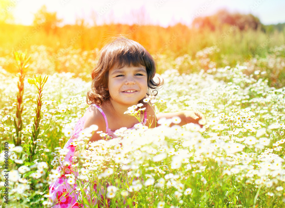 Happy little girl in flower meadow in sunny day Happy little girl in flower meadow in sunny day