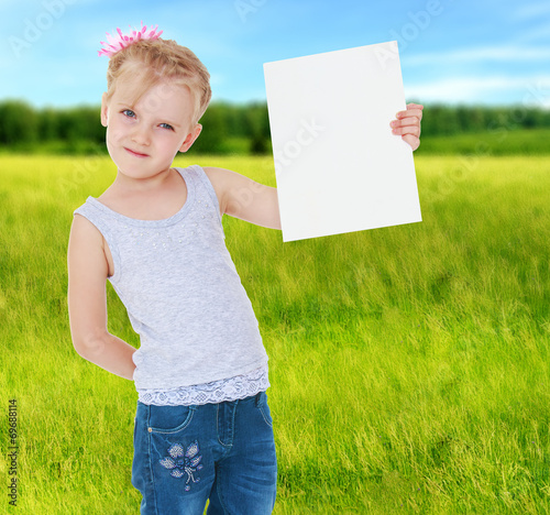 girl holding a square white sheet on which you can write somethi photo