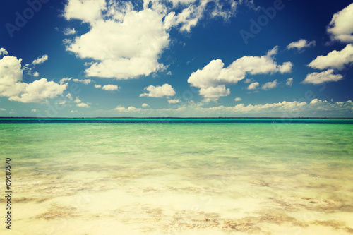 blue sea or ocean  white sand and sky with clouds