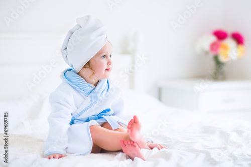 Litlte girl in a bathrobe and towel photo