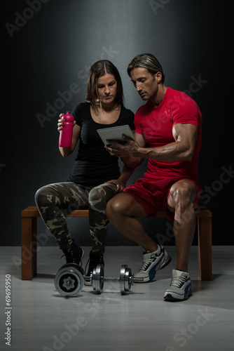 Fit Attractive Young Couple Looking At A Tablet