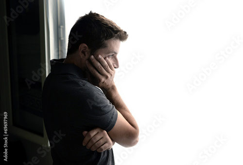 Fotografie attractive man looking through window suffering depression