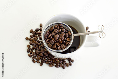 Coffee cup and coffee bean on white background