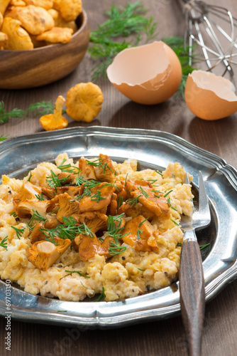 delicious scrambled eggs with chanterelles and fresh dill