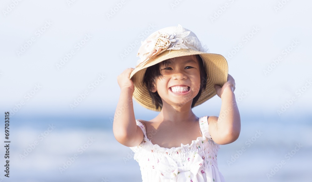 Close up photo of cute little Asian girl on the beach