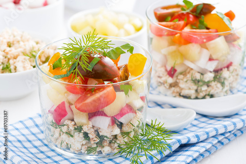 fresh vegetable salad with cottage cheese in a glass on table