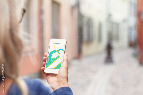 Tourist using navigation app on the mobile phone