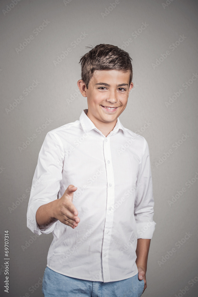 Young smiling man giving arm for handshake, grey background Young smiling man giving arm for handshake, grey background