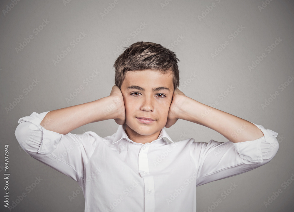 Boy covering ears with hands. Hear no evil concept Boy covering ears with hands. Hear no evil concept
