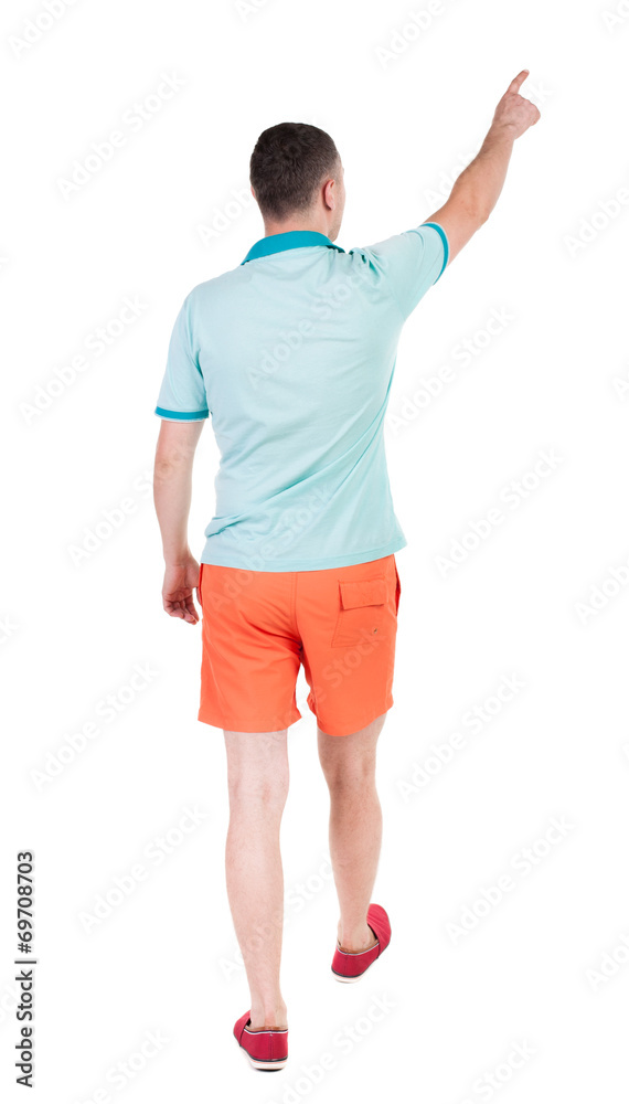 Back view of going handsome man in shorts. walking young guy Back view of going handsome man in shorts. walking young guy