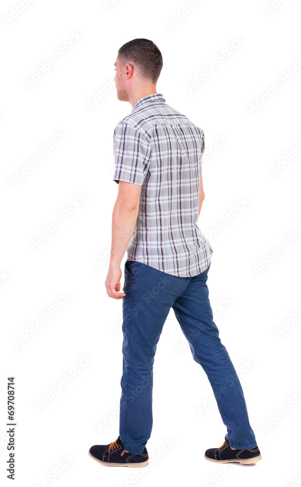 Back view of going handsome man in jeans and a shirt. Back view of going handsome man in jeans and a shirt.