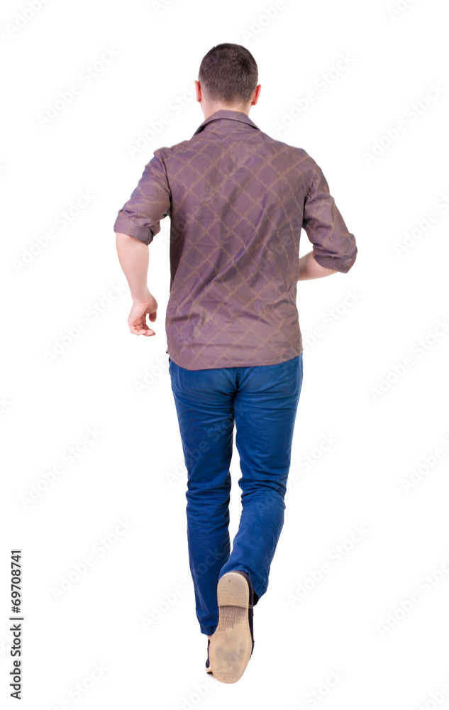 Back view of running man in brown shirt. Back view of running man in brown shirt.