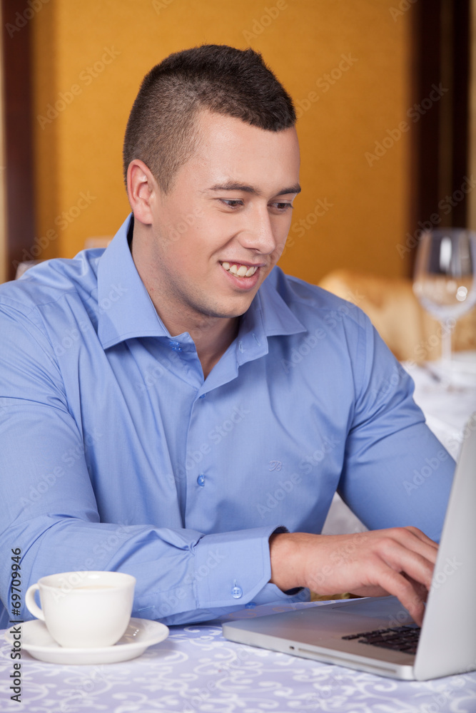 closeup of handsome man sitting in cafe and drinking coffee. closeup of handsome man sitting in cafe and drinking coffee.