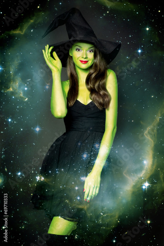 Beautiful young woman as halloween witch