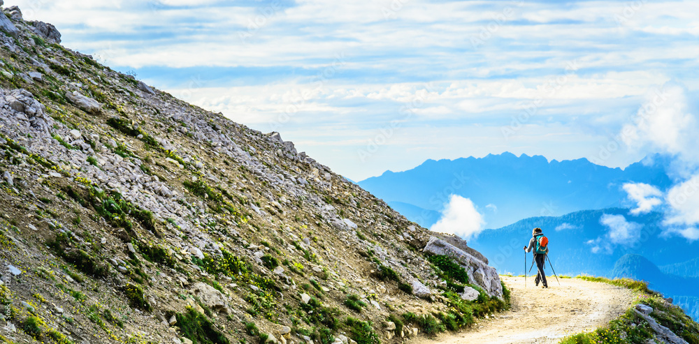 Woman hiker on mountain trail near Tre Cime, Dolomites