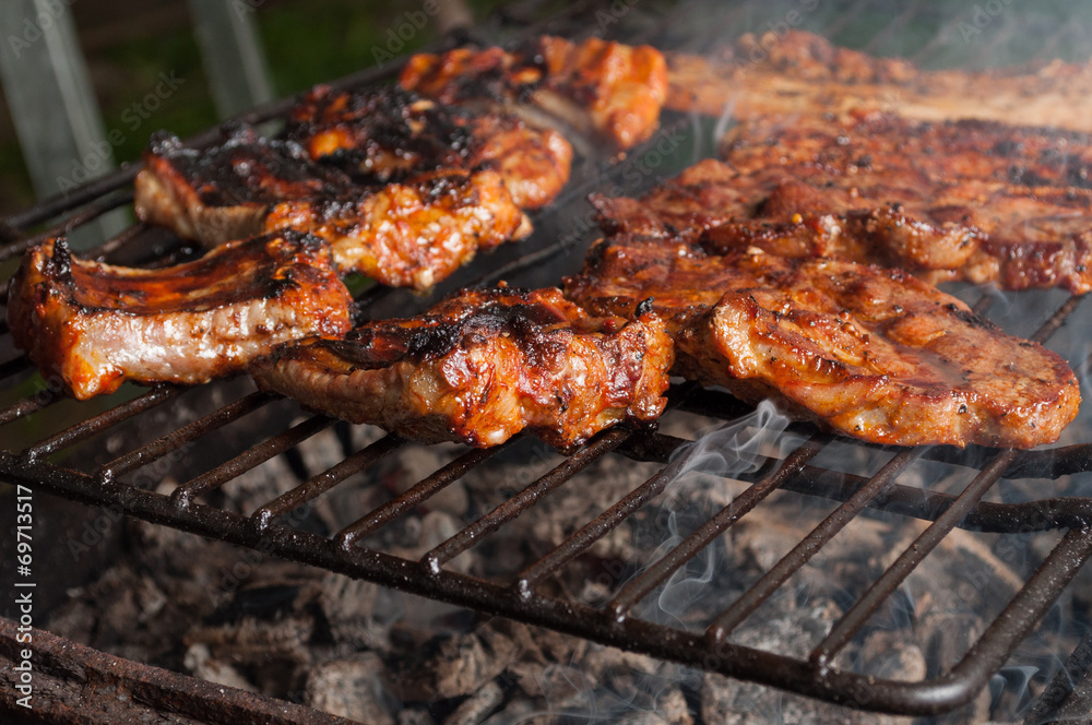 Closeup of delicious pork ribs on barbeque grill.
