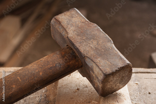 Closeup of an old hammer on wood table.