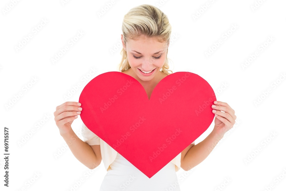 Attractive young blonde showing red heart Attractive young blonde showing red heart
