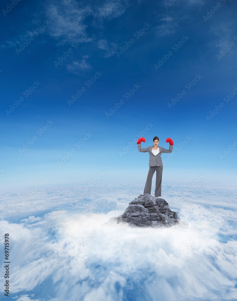 Composite image of businesswoman with boxing gloves Composite image of businesswoman with boxing gloves