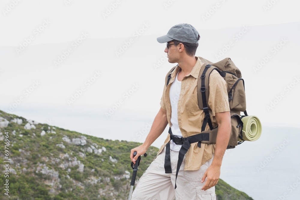 Hiking man walking on mountain terrain Hiking man walking on mountain terrain