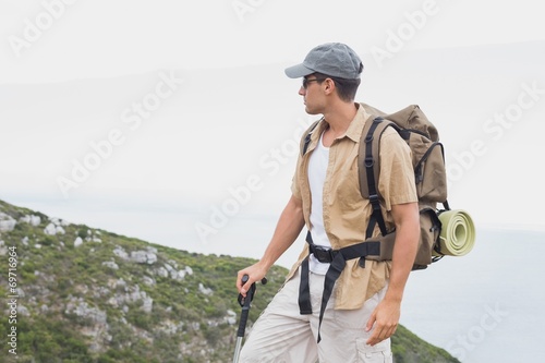 Hiking man walking on mountain terrain