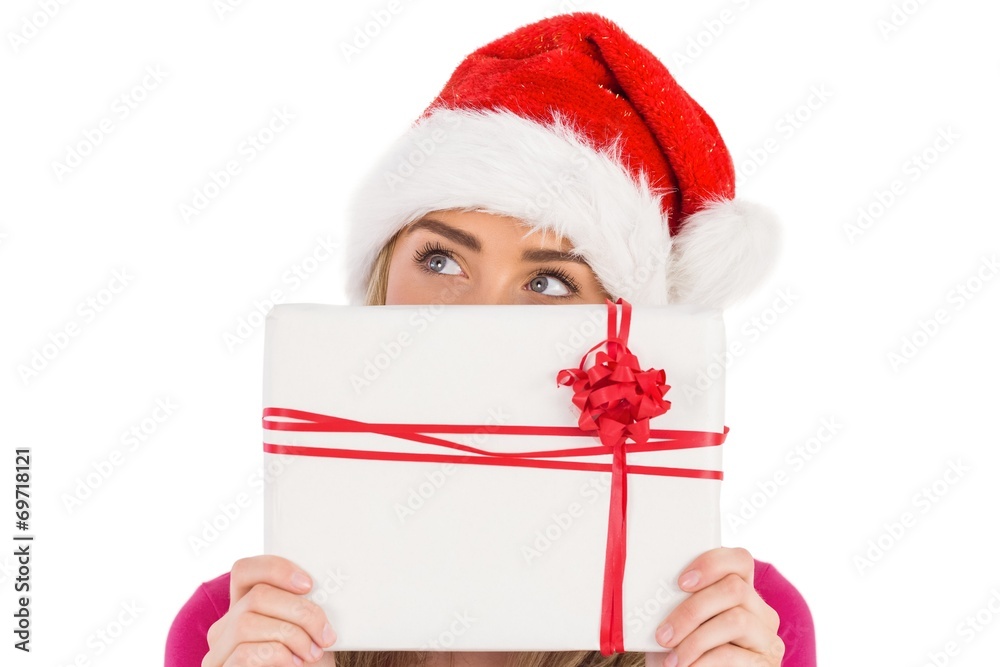 Festive blonde holding christmas gift Festive blonde holding christmas gift