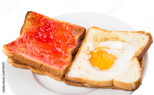 Bread toast with fried egg and strawberry jam