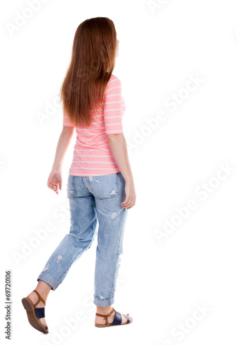 back view of walking woman .
