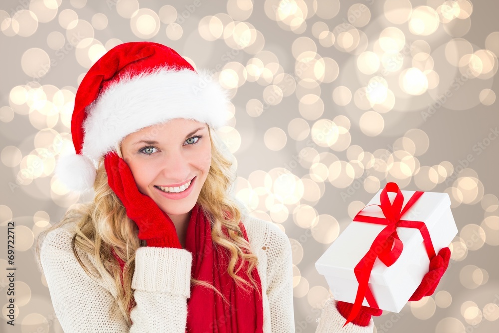 Composite image of happy festive blonde with gift Composite image of happy festive blonde with gift