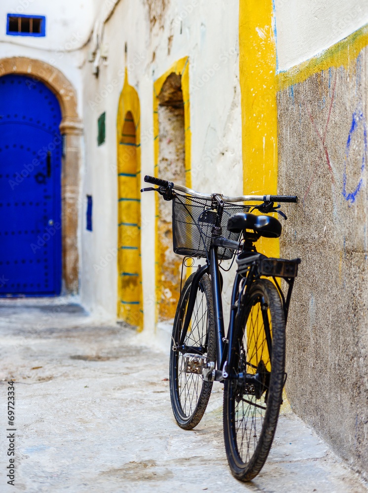 A bicycle leaning to a colorful wall in downtown A bicycle leaning to a colorful wall in downtown