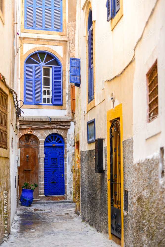 Narrow traditional street with buildings with colorful doors