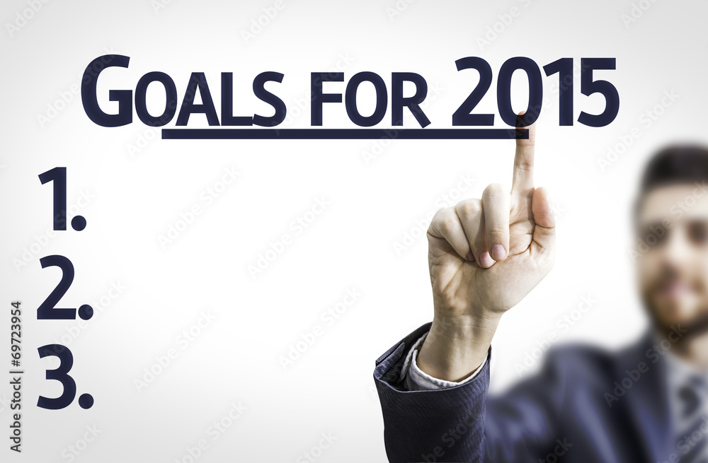 Business man pointing the text: Goals for 2015 Business man pointing the text: Goals for 2015