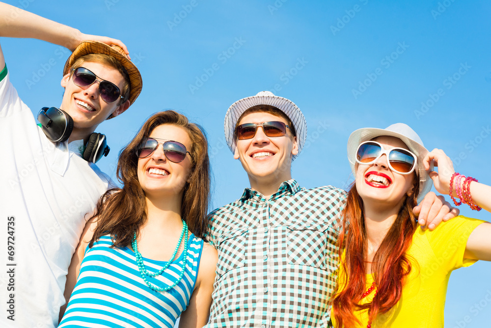 group of young people wearing sunglasses and hat