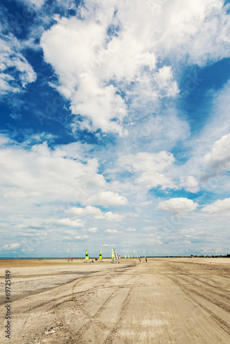 Land sailing on the a beach. Historically, land sailing was used