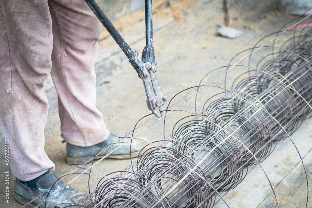 Worker cut steel with iron scissors in Construction