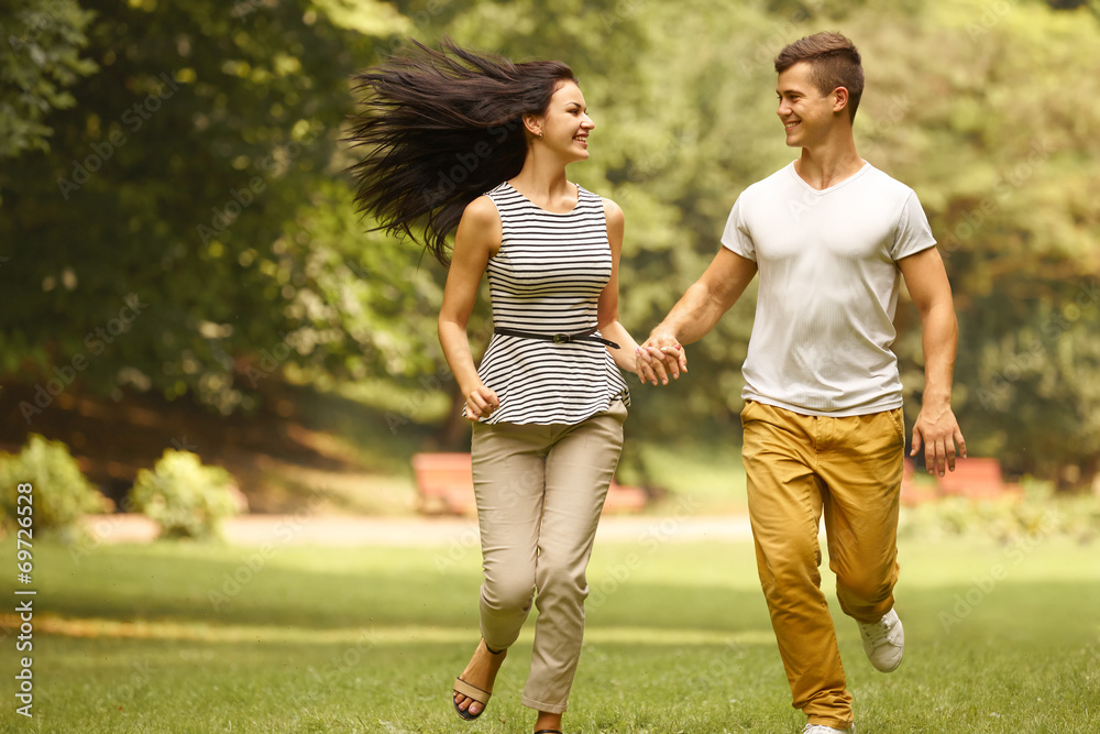 Couple in Love. Happy Couple Running in the park Couple in Love. Happy Couple Running in the park