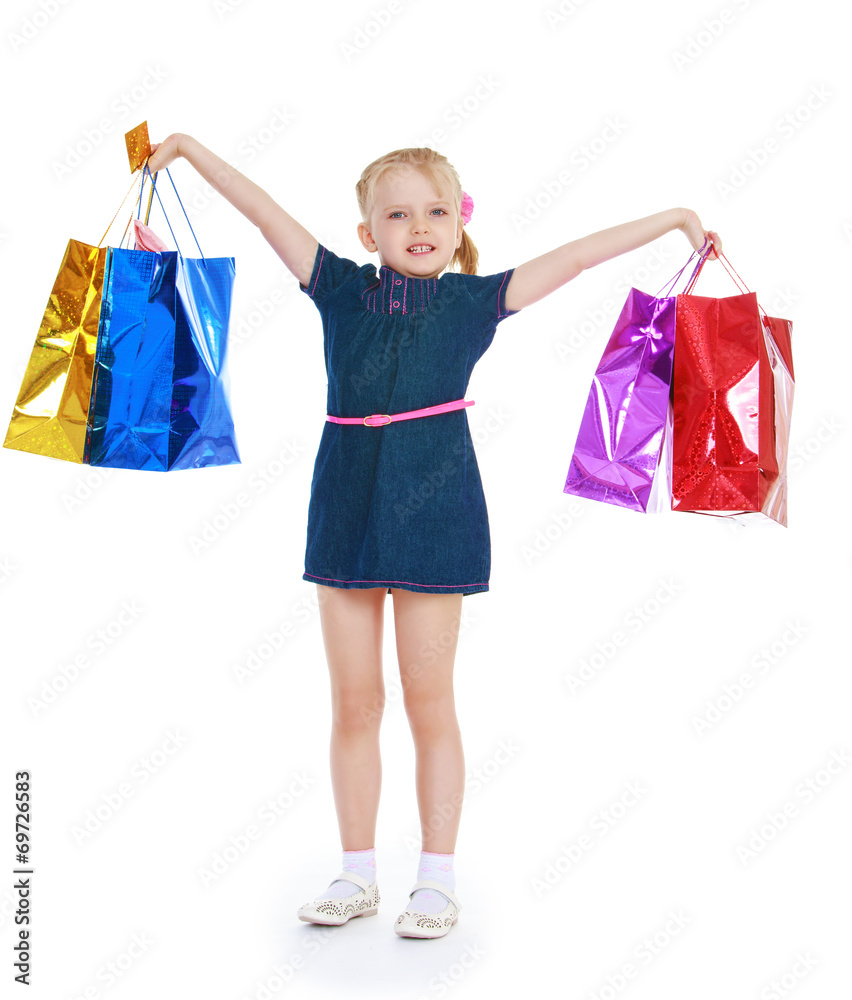 girl raised her hands holding them in shopping bags