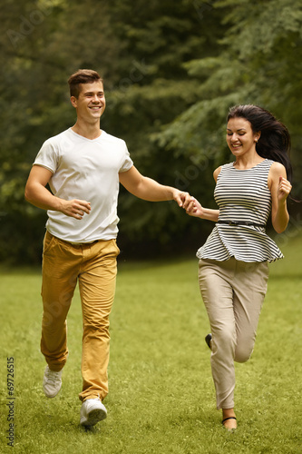Couple in Love. Happy Couple Running in the park