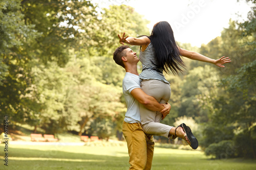 Happy couple has a fun in summer park