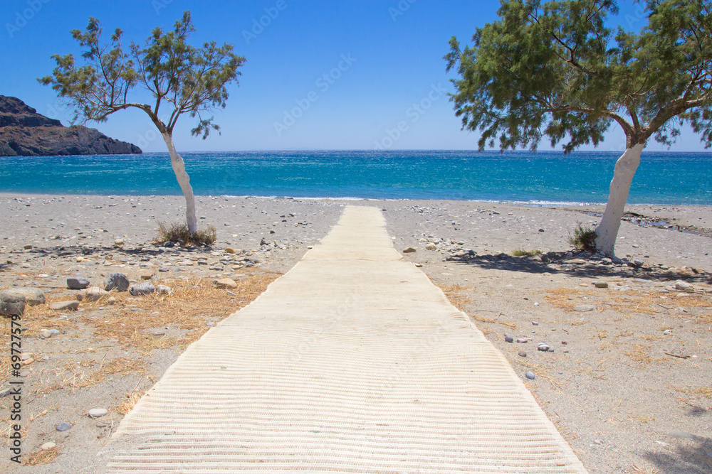 path to the beach with blue transparent water
