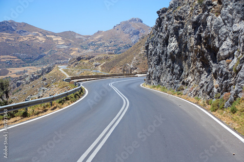 winding road leading to the mountains in Greece
