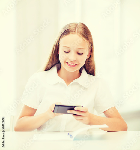 girl with smartphone at school
