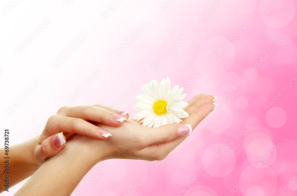 Young woman hands with elegance manicure on bright background Young woman hands with elegance manicure on bright background