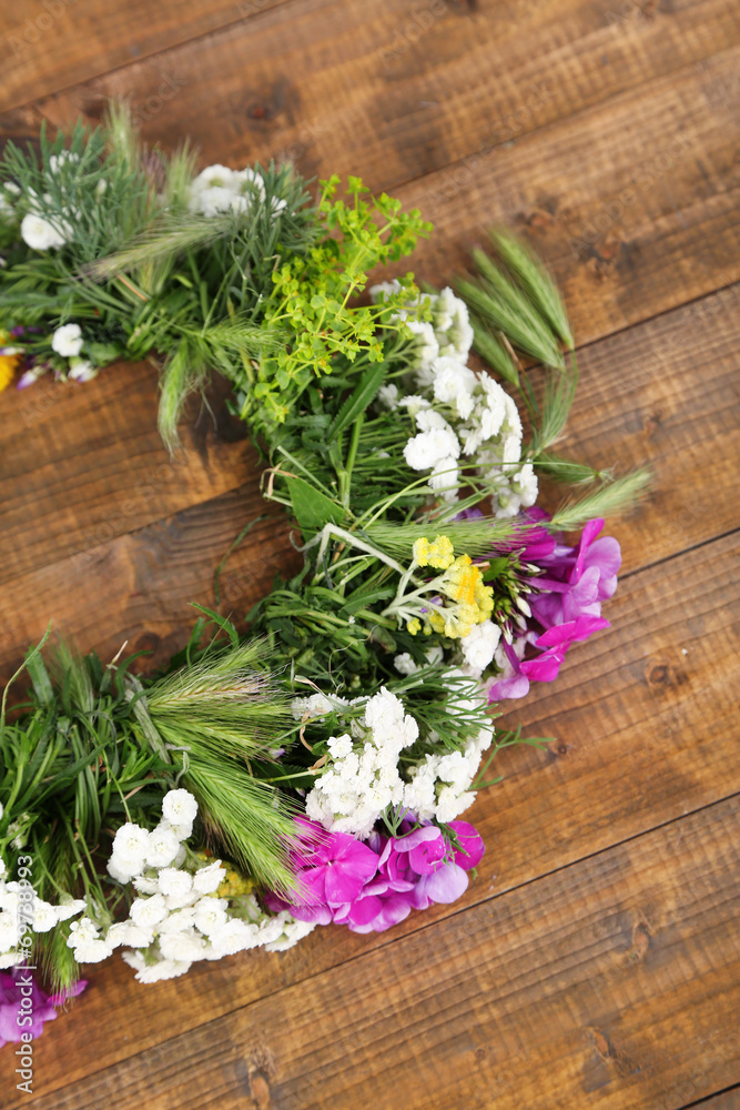 Wildflower wreath on wooden background Wildflower wreath on wooden background