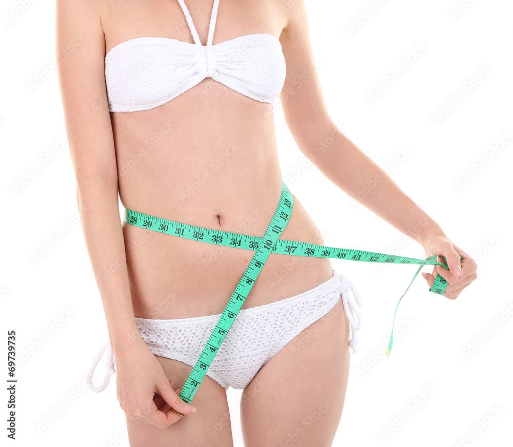 Beautiful young woman measuring her body with tape isolated