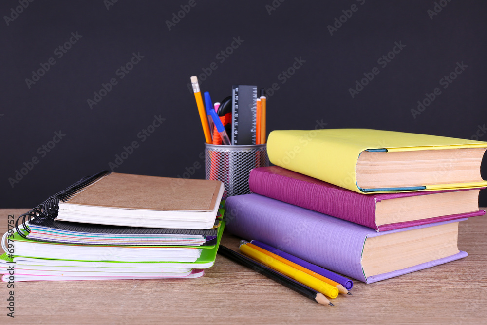 School supplies on table on dark background School supplies on table on dark background