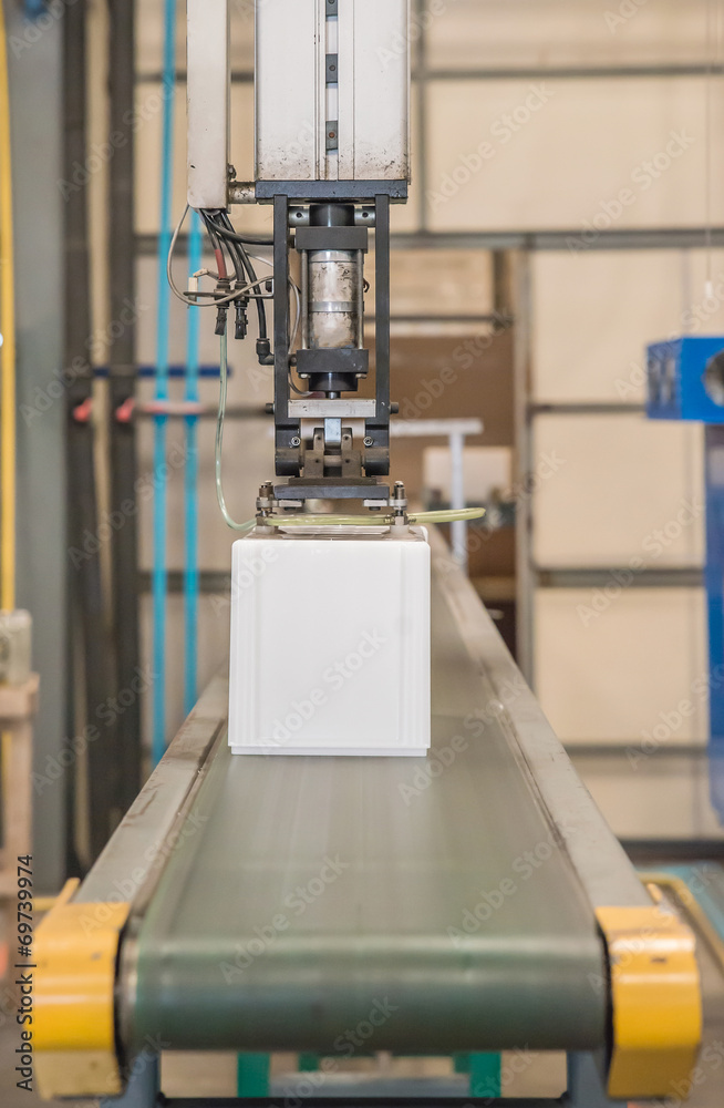 Industrial robot working in plastic factory