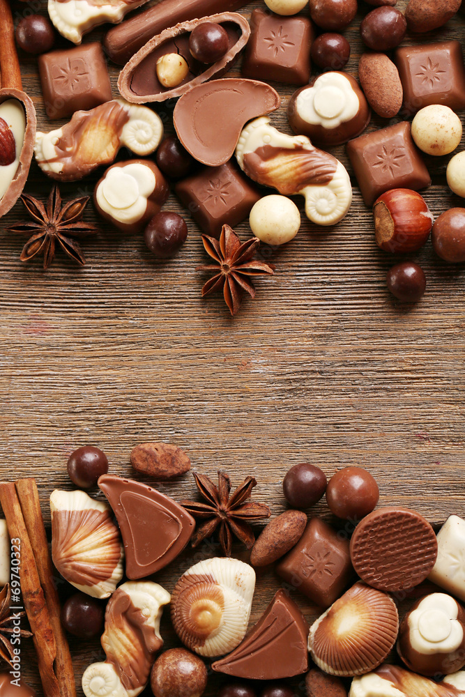 Different kinds of chocolates on wooden table close-up