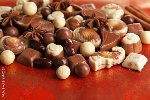 Different kinds of chocolates on red background