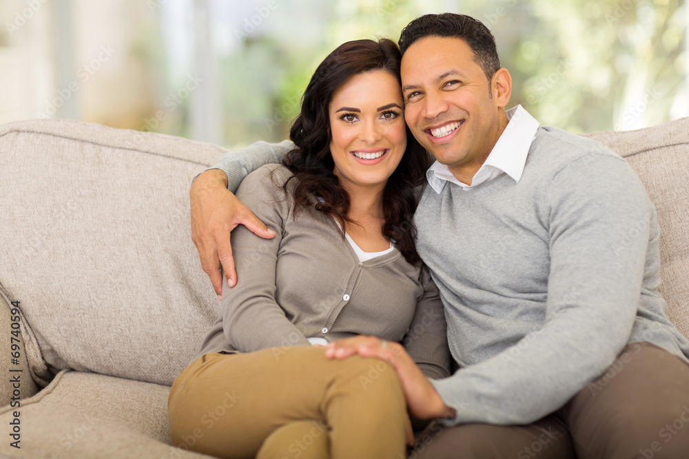 couple sitting on sofa at home couple sitting on sofa at home